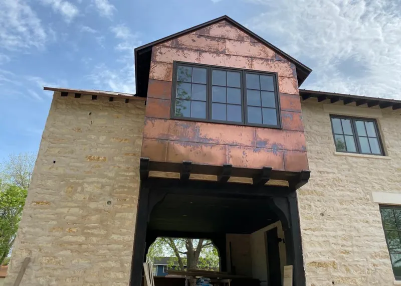Copper metal panel facade on a stone building for Skylight Installation in Sanford