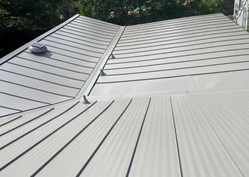 Solar attic fan installed on a metal roof for Roof Ventilation in Sanford